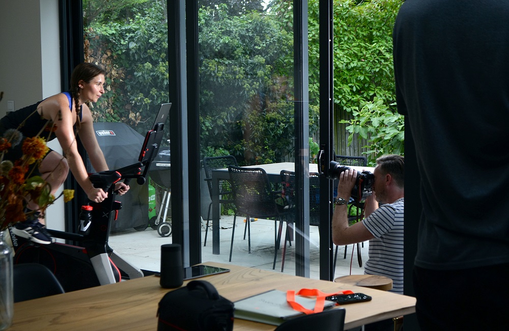 sports model being filmed on exercise bike