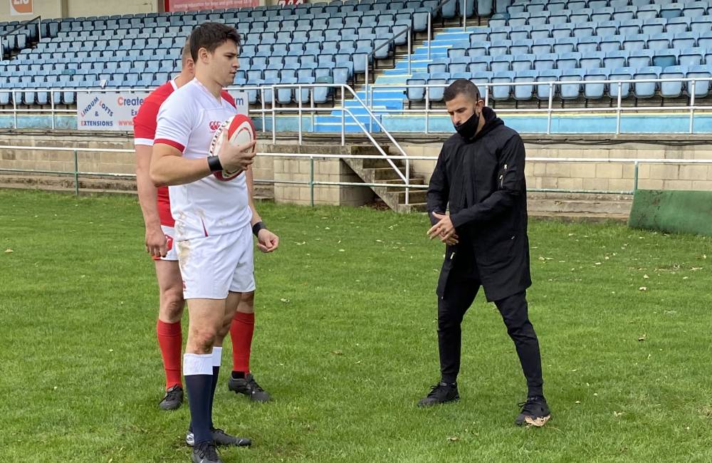 choreographer instructing sports talent on set