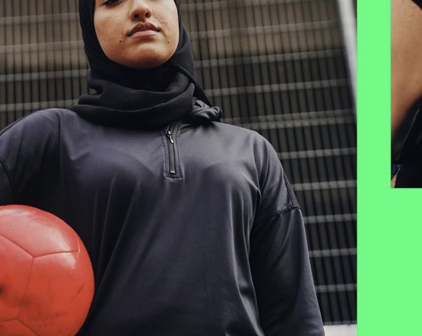 lady holding football for kick it out campaign