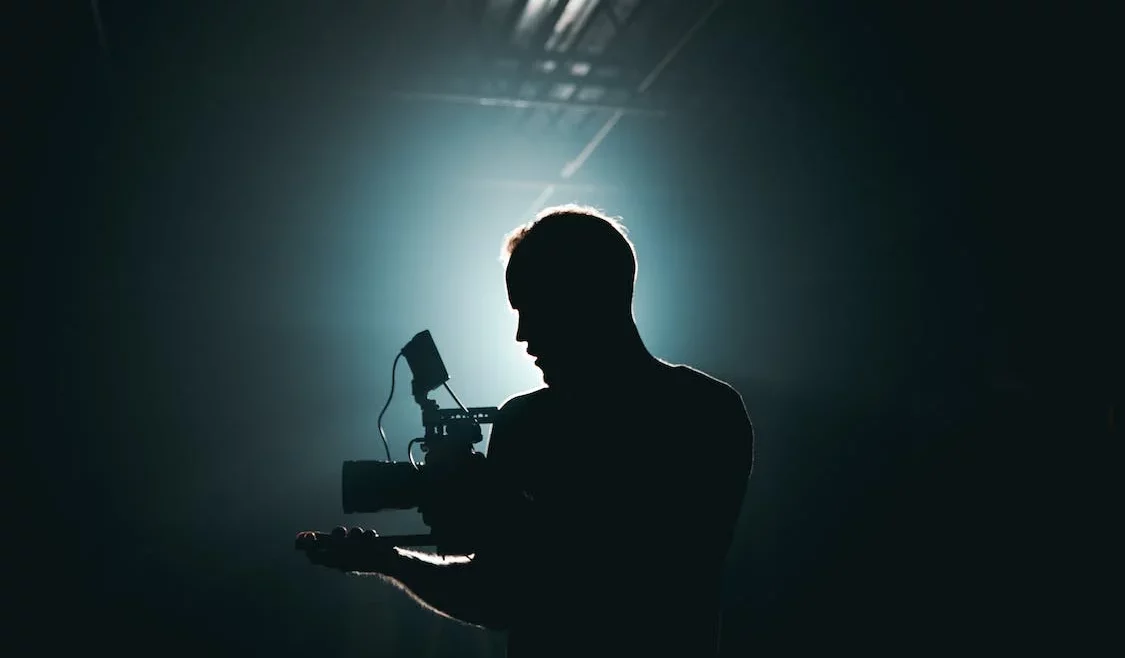 man filming in the dark